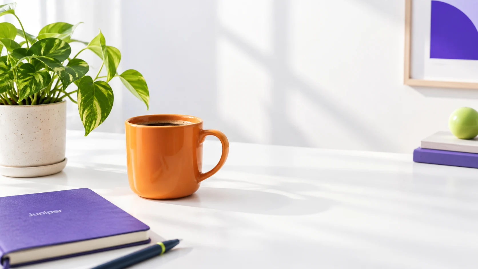 Illustrative source-photo example showing an orange mug and leafy plant on an uncluttered desk